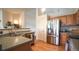 Kitchen featuring stainless steel appliances, wood cabinetry, and lots of counter space at 12606 S Sopris Creek Dr, Parker, CO 80134