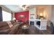 Inviting living room featuring wood floors, a fireplace, and comfortable seating, perfect for entertaining guests at 12606 S Sopris Creek Dr, Parker, CO 80134