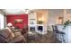 Inviting living room with a cozy fireplace, wood floors, and a comfortable seating area perfect for relaxing at 12606 S Sopris Creek Dr, Parker, CO 80134