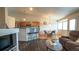 Open concept living room boasts breakfast bar, seating area, and hardwood floors at 12606 S Sopris Creek Dr, Parker, CO 80134