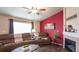 Comfortable living area featuring a fireplace, wood floors, and natural light with plush furniture at 12606 S Sopris Creek Dr, Parker, CO 80134