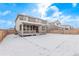 Backyard showing covered patio, lawn, fencing and the back of the two-story home at 14769 Dahlia St, Thornton, CO 80602