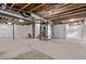 Unfinished basement with concrete floor, visible utilities, and white plastic sheeting on the walls at 14769 Dahlia St, Thornton, CO 80602