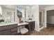 Bright bathroom featuring dual vanities with modern fixtures and elegant stone countertops at 14769 Dahlia St, Thornton, CO 80602