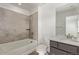 A bathroom with a tiled shower, bathtub, commode, and modern vanity at 14769 Dahlia St, Thornton, CO 80602