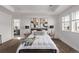 Bedroom boasts bright natural light, tray ceiling, and plush carpet flooring at 14769 Dahlia St, Thornton, CO 80602