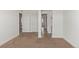 Large bedroom with neutral walls and carpet featuring multiple doorways and entryways at 14769 Dahlia St, Thornton, CO 80602