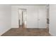 A spacious bedroom with neutral walls and carpet flooring showcases a tiled doorway at 14769 Dahlia St, Thornton, CO 80602