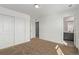 Bedroom features neutral walls, carpet flooring, and entry to bathroom at 14769 Dahlia St, Thornton, CO 80602