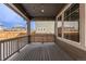Covered back patio features wood flooring, string lights, and view of backyard and adjacent houses at 14769 Dahlia St, Thornton, CO 80602
