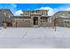 Charming two-story home featuring a welcoming front porch, a two car garage and a snow-covered yard at 14769 Dahlia St, Thornton, CO 80602