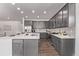 Well-lit kitchen featuring gray cabinets, stainless steel appliances, a white countertop, and wood floors at 14769 Dahlia St, Thornton, CO 80602