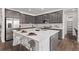 Kitchen featuring stainless steel appliances, large center island, and gray cabinetry at 14769 Dahlia St, Thornton, CO 80602