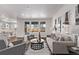 Bright living room featuring hardwood floors, recessed lights, neutral decor, and large windows at 14769 Dahlia St, Thornton, CO 80602