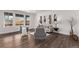 Living room with hardwood flooring, neutral paint, and large windows for ample natural light at 14769 Dahlia St, Thornton, CO 80602