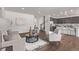 Open-concept living room with modern furniture and hardwood floors that flows into the kitchen at 14769 Dahlia St, Thornton, CO 80602