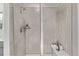 Modern shower with gray tile, sleek fixtures, and convenient built-in bench at 14769 Dahlia St, Thornton, CO 80602
