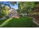 Large grassy backyard with mature trees and a patio at 13471 Cascade St, Broomfield, CO 80020