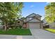 House exterior with a two-car garage and well-manicured lawn at 13471 Cascade St, Broomfield, CO 80020