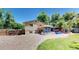 Large backyard with a deck, pergola, hot tub, and various garden features at 7722 W 1St Pl, Lakewood, CO 80226