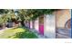 Unique backyard with a colorful fence and lush green lawn at 7722 W 1St Pl, Lakewood, CO 80226