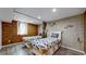 Basement bedroom with twin beds, unique wall decor, and wood floors at 7722 W 1St Pl, Lakewood, CO 80226