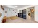 Basement entry with coat rack and built-in shelving at 7722 W 1St Pl, Lakewood, CO 80226