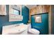 Basement bathroom with teal walls and rustic wood accents at 7722 W 1St Pl, Lakewood, CO 80226