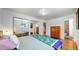 Bright bedroom with mirrored closet doors and hardwood floors at 7722 W 1St Pl, Lakewood, CO 80226