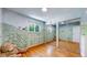 Charming bedroom with a whimsical mural and mirrored closet at 7722 W 1St Pl, Lakewood, CO 80226