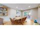 Dining room with hardwood floors and view into kitchen and living room at 7722 W 1St Pl, Lakewood, CO 80226