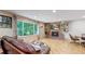 Bright living room featuring a brick fireplace and hardwood floors at 7722 W 1St Pl, Lakewood, CO 80226