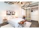 Bright bedroom featuring an open closet system, modern decor and concrete floors in a converted industrial space at 1777 E 39Th Ave # 209, Denver, CO 80205