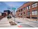 Exterior view of a red brick building with street and building sign visible at 1777 E 39Th Ave # 209, Denver, CO 80205
