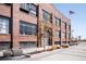 Exterior of a red brick building with large windows at 1777 E 39Th Ave # 209, Denver, CO 80205