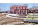 A unique pink historic building offers a bar and grill, complemented by new landscaping and stepped terraces at 1777 E 39Th Ave # 209, Denver, CO 80205