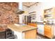 Stylish kitchen featuring stainless steel appliances, light wood cabinetry, and sleek countertops at 1777 E 39Th Ave # 209, Denver, CO 80205