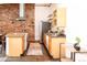 Modern kitchen with exposed brick, stainless steel appliances, and light wood cabinetry at 1777 E 39Th Ave # 209, Denver, CO 80205