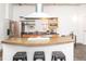 Bright kitchen with island, stainless steel appliances, and open shelving for storage at 1777 E 39Th Ave # 209, Denver, CO 80205