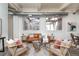 Bright living room with exposed ductwork, large windows, contemporary furnishings, and stylish decor at 1777 E 39Th Ave # 209, Denver, CO 80205