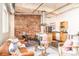 Open concept living space with exposed brick, stainless steel appliances, and modern furnishings at 1777 E 39Th Ave # 209, Denver, CO 80205