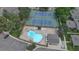 Aerial view of community pool, tennis courts, and parking at 10001 E Evans Ave # D, Aurora, CO 80247