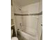 Well-lit bathtub with white subway tile and a shower head at 10001 E Evans Ave # D, Aurora, CO 80247