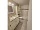 Bright bathroom featuring a granite vanity top, sleek fixtures, and modern tile flooring at 10001 E Evans Ave # D, Aurora, CO 80247