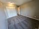 An empty bedroom with closet, carpeting, and doorway at 10001 E Evans Ave # D, Aurora, CO 80247