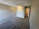 Bedroom with plush carpeting, closet, and a doorway leading to another room at 10001 E Evans Ave # D, Aurora, CO 80247