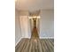 Hallway with wood flooring, neutral paint and a closet for storage at 10001 E Evans Ave # D, Aurora, CO 80247