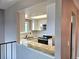 Kitchen with white cabinets, stainless steel appliances, and a granite countertop bar overlooking the dining area at 10001 E Evans Ave # D, Aurora, CO 80247