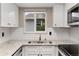 Kitchen with stainless steel appliances, granite countertops, and subway tile at 10001 E Evans Ave # D, Aurora, CO 80247