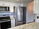 A well-equipped kitchen with stainless steel appliances, including microwave and refrigerator at 10001 E Evans Ave # D, Aurora, CO 80247